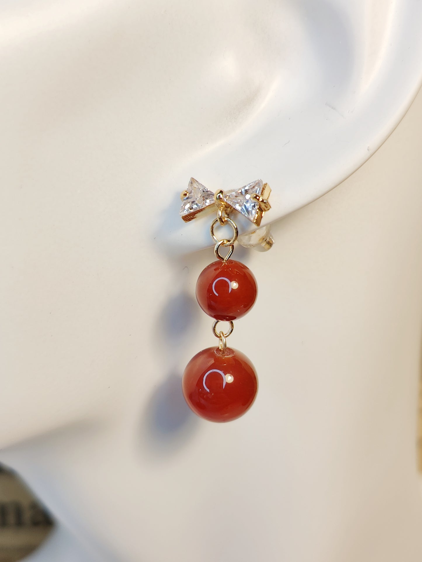 Bow-Shaped Zircon Stud Earrings with Red Stone Bead Accents