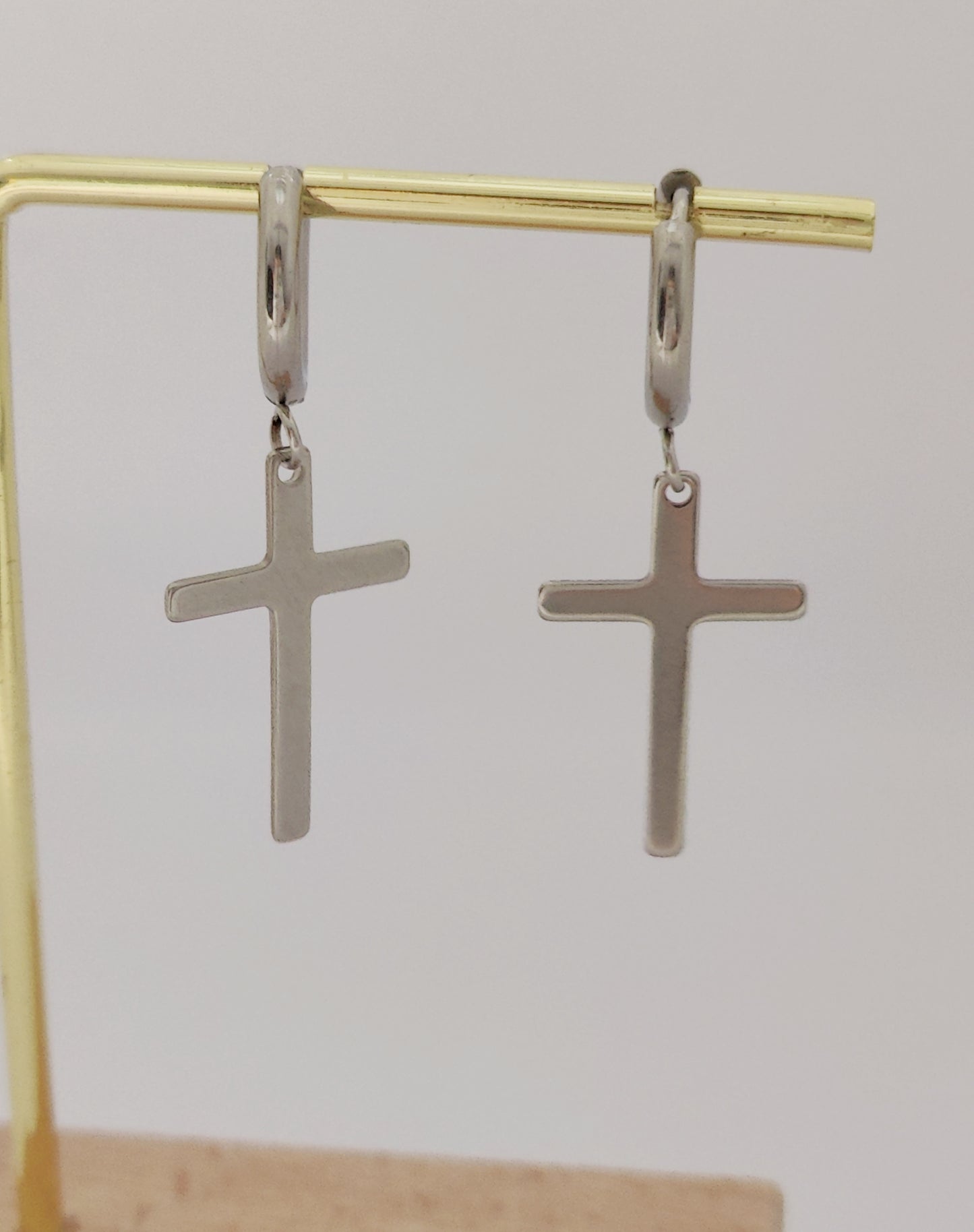 Round earrings with thin cross pendant